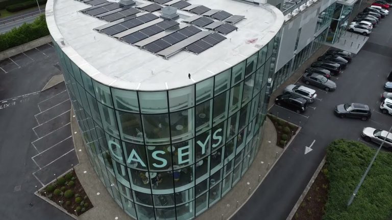 Solar panels on the roof of the Caseys Furniture store in Raheen, Limerick, with the CASEYS glass facade below